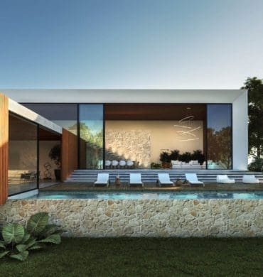 Área de lazer de casa com arquitetura contemporânea, com piscina em formas retas, cadeiras de sol e espaço arborizado.